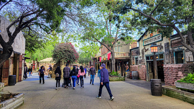 people walking through the old ghost town in knott's berry