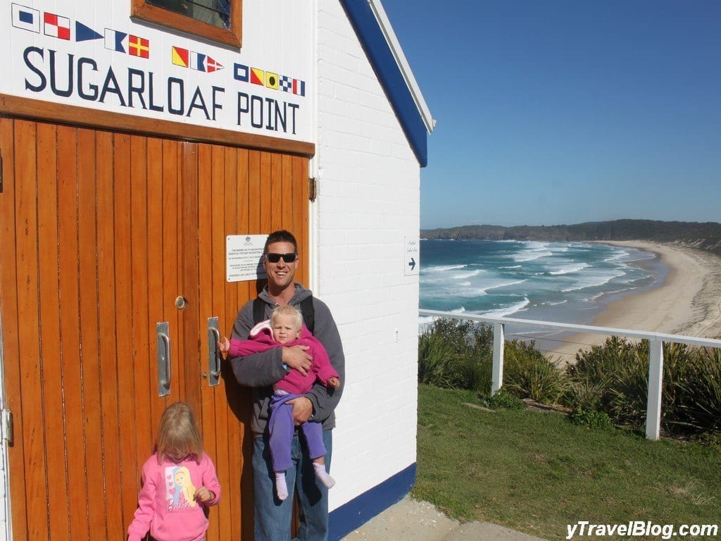 a man and children standing next to a door