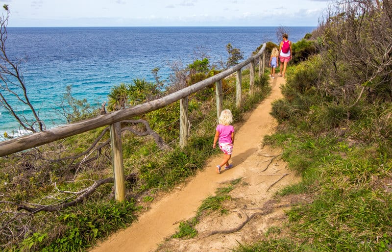 family walking along trail beside ocean Noosa Heads National Park