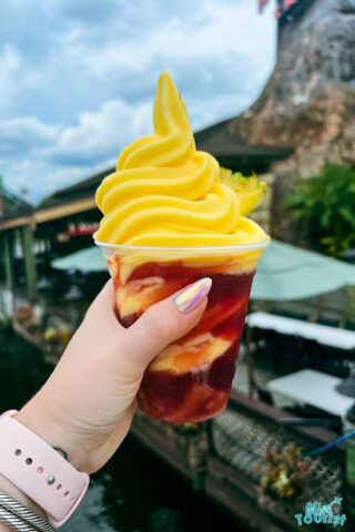 hand holding a glass of ice cream