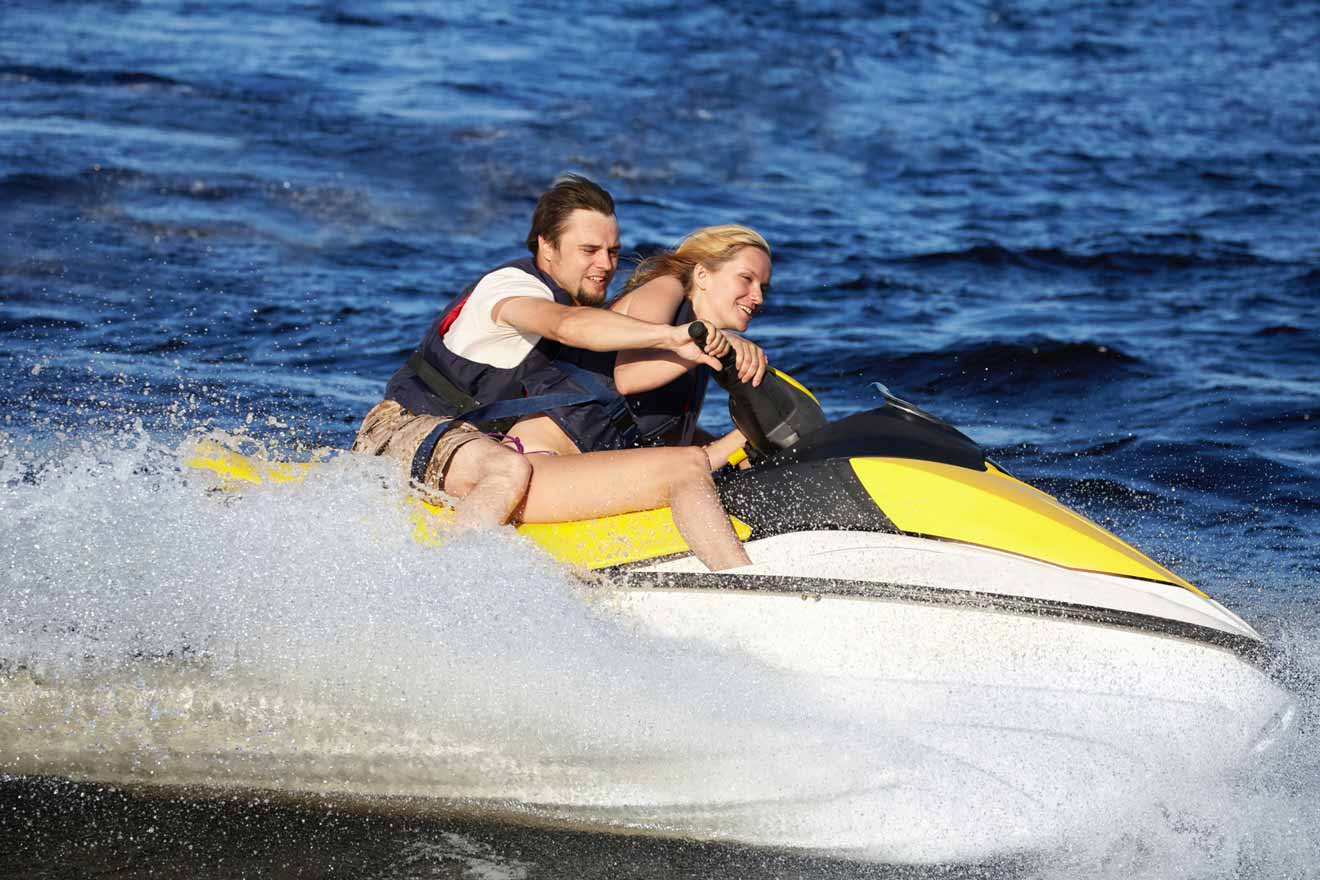 couple riding jet ski