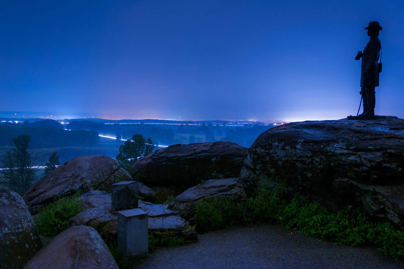 person watching from the top of a hill at night