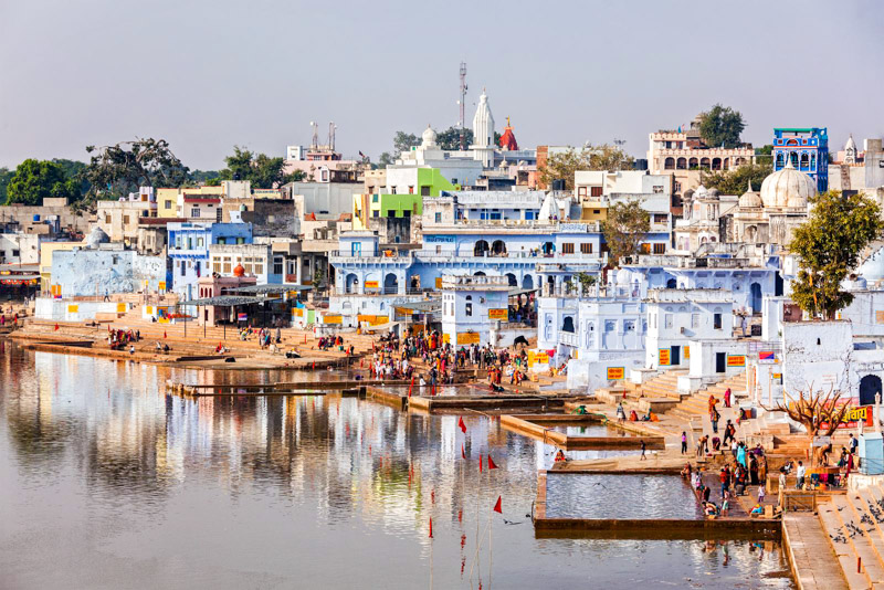 Hindu devotees pilgrims bathing in sacred Puskhar lake (Sagar) on ghats of Pushkar