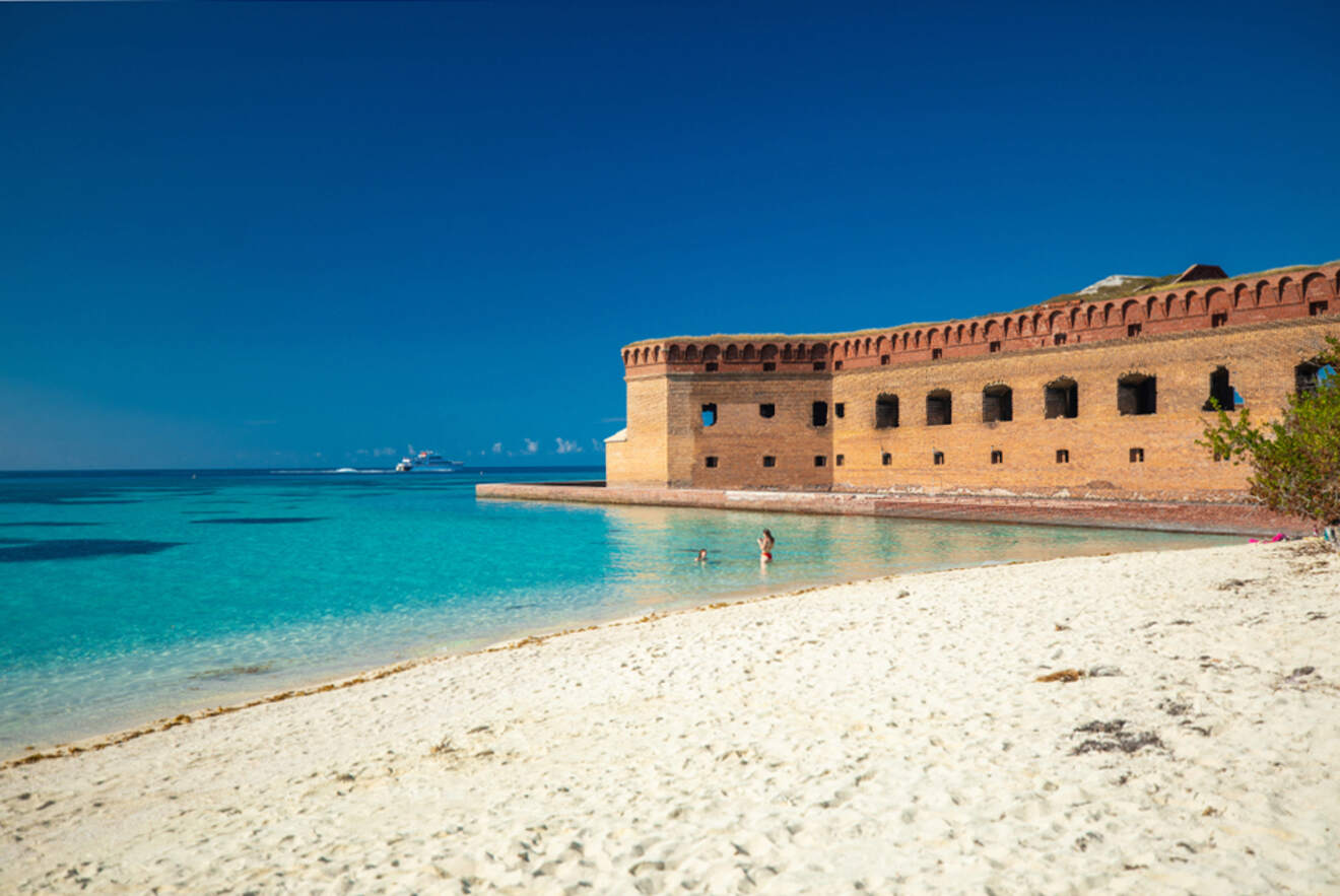 sandy beach with a fort in the background