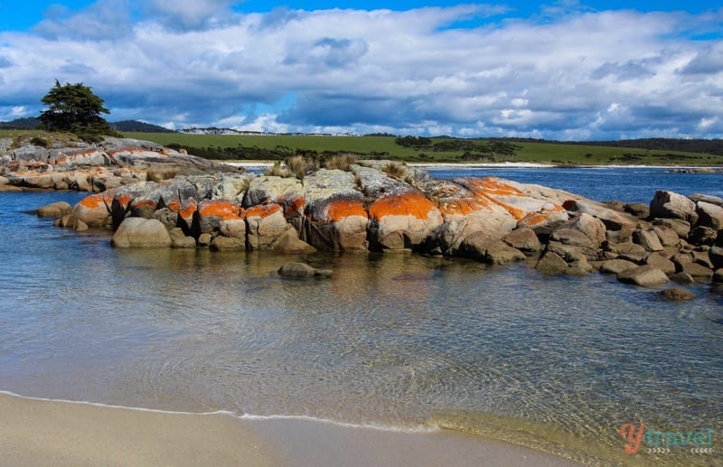 orange rocks surrounded by water