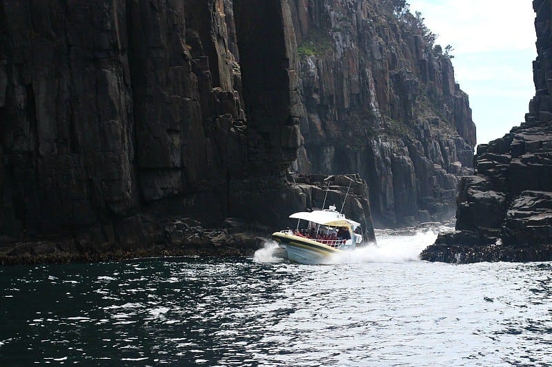 a boat going in between rocks