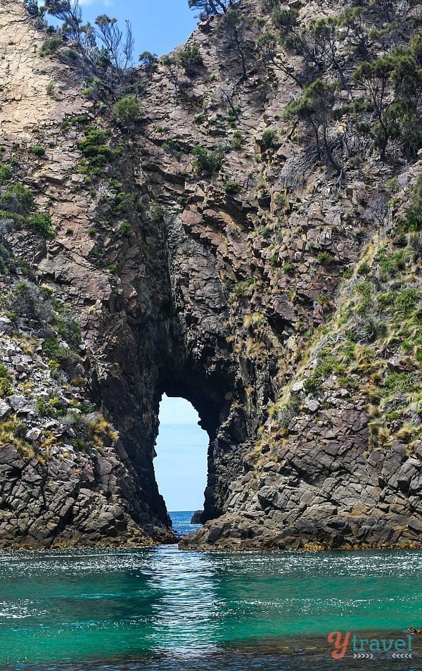 a rock arch in the ocean