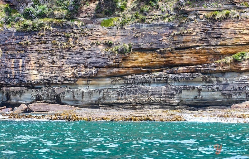 water next to a rock wall