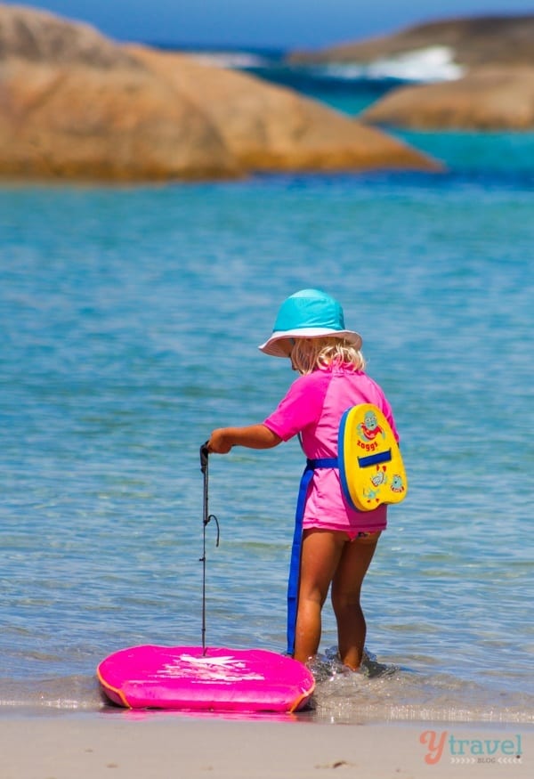 girl walking into the ocean