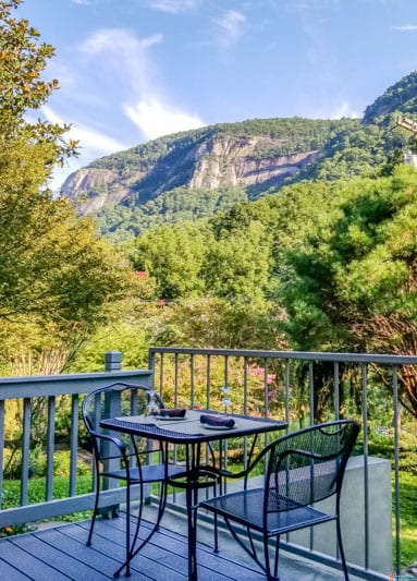 table and chair on patio with mountain views at the Esmeralda Inn Lake Lure