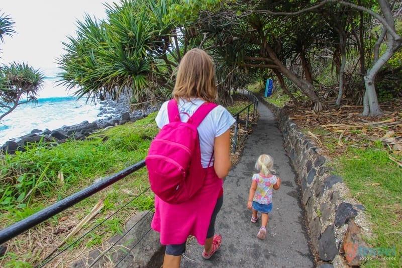 woman and child walkign trail along headland