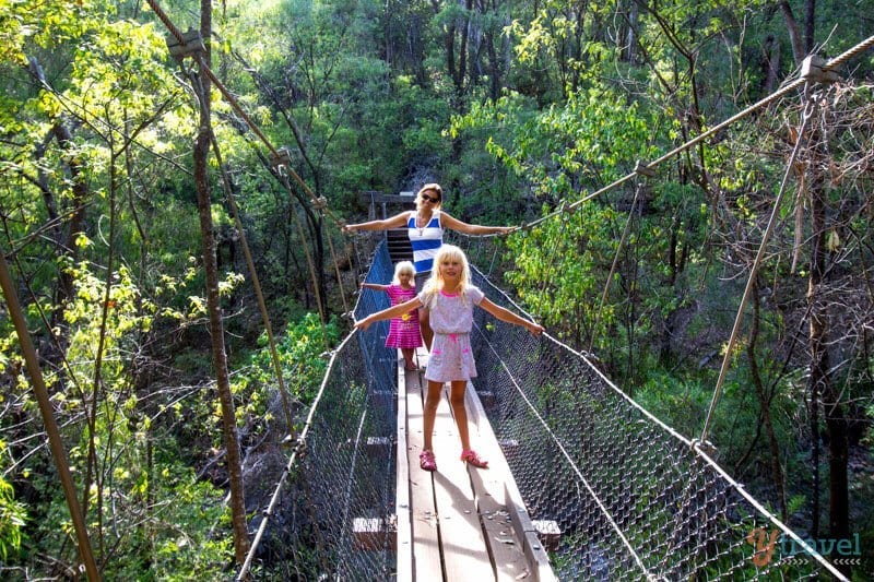 people walking across a bridge