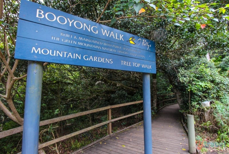 a blue sign on a pathway