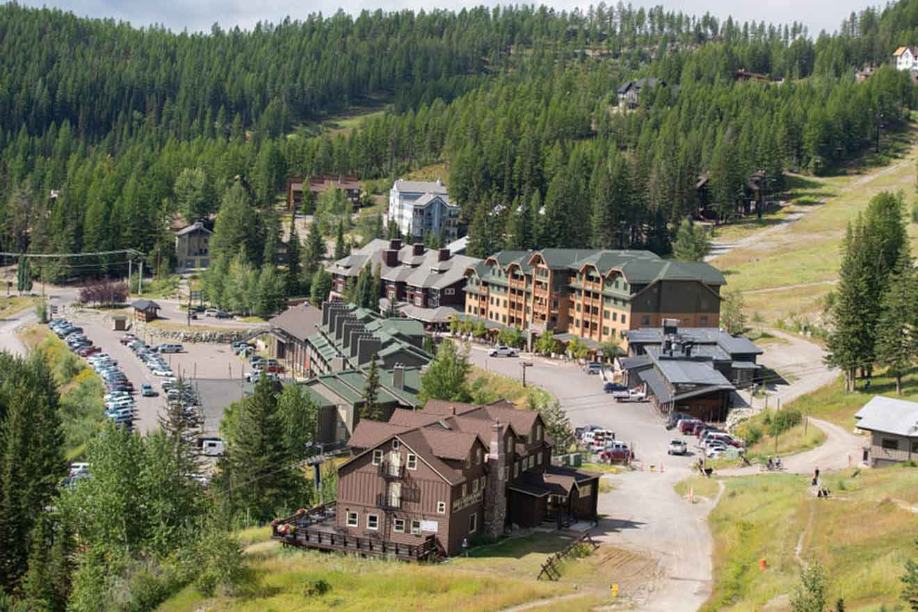 aerial view with buildings, parking spaces and lots of trees