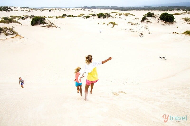 people walking on sand dunes