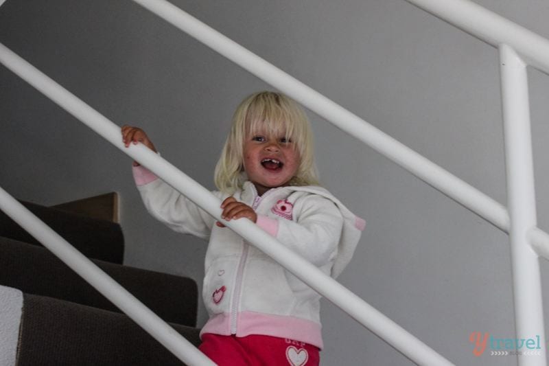 a girl standing on a staircase