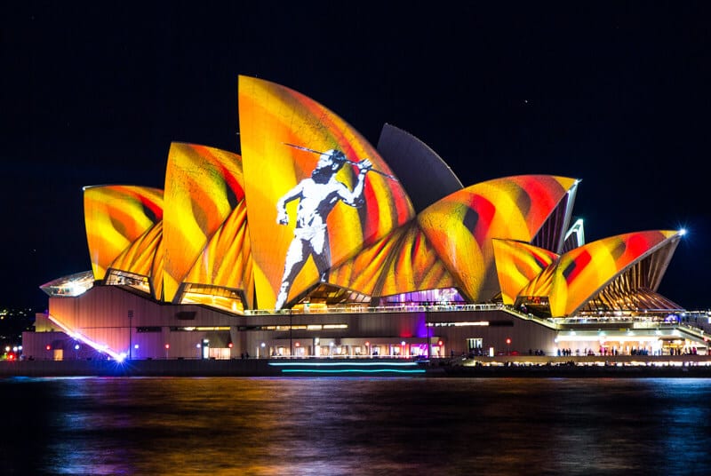 light projections on a the sydney opera hoes of aboriginal man with spear