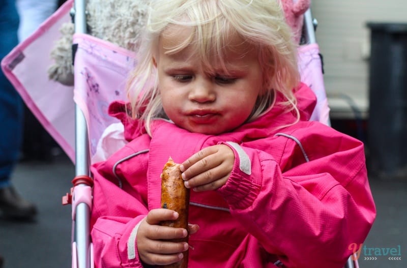 A little girl holding a sandwich