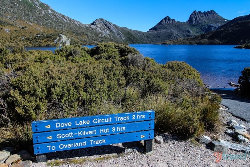 A blue sign sitting on the side of a mountain