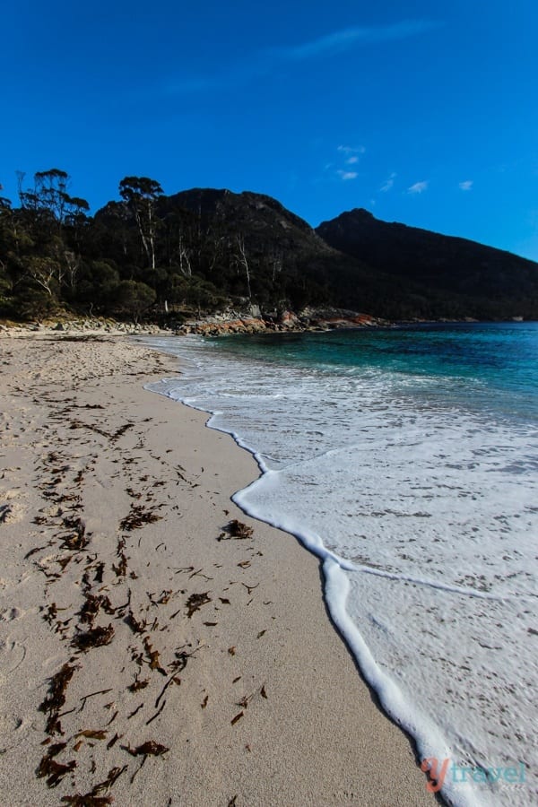 A sandy beach next to the water