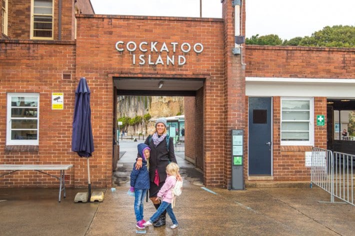 woman and children posing out from of Cockatoo Island entrance