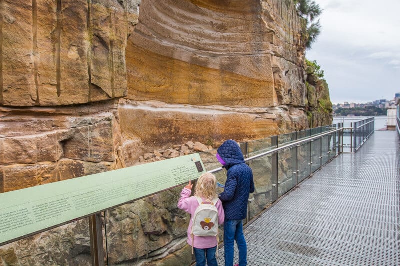 girls reading information board on trail