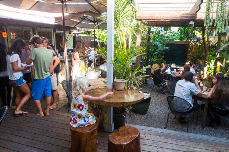 people sitting at tabels and chairs in courtyard of Paia Bay Coffee, Maui