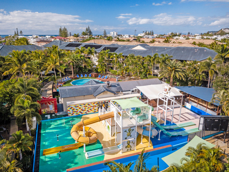 aerial view of turtle beach resort pool area and surfers skyline in background