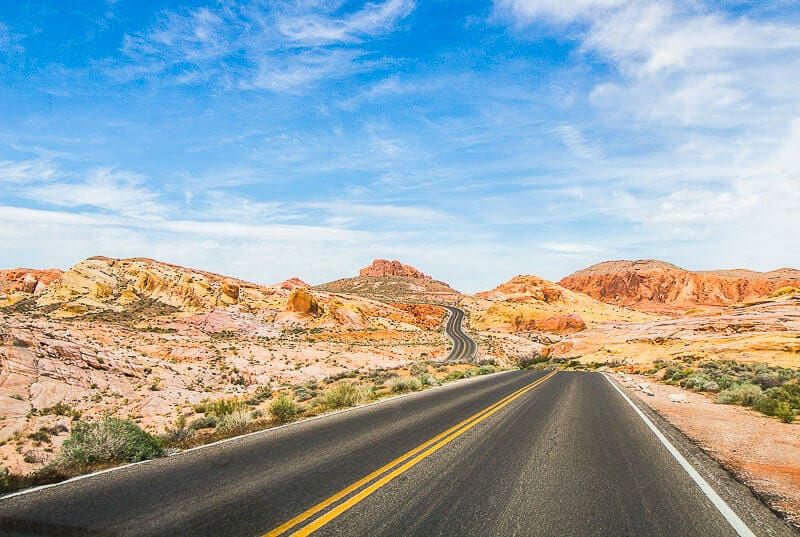 road winding through orange and pink landscape of VAlley of Fire