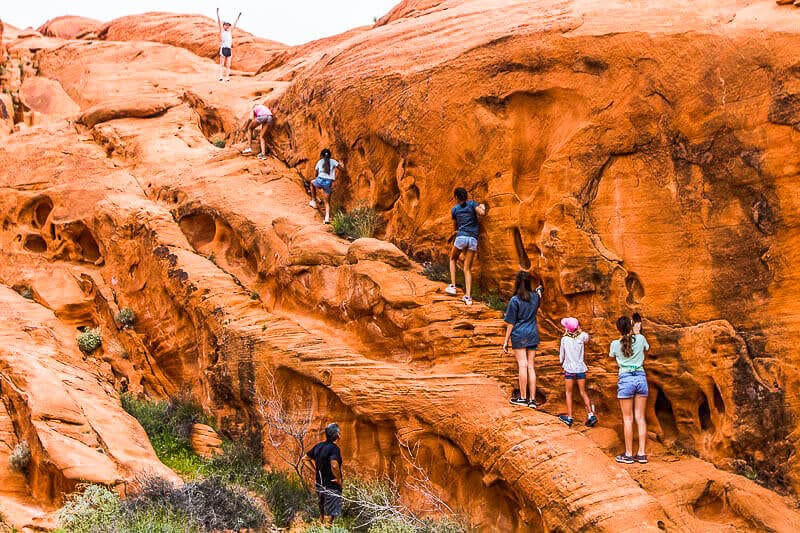 people walking up rock son the Mouse Tank trails