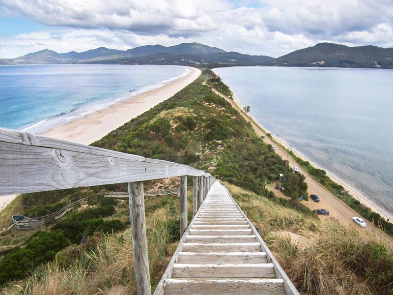 The Neck Lookout Looking down a staircase at a very narrow isthmus with a road along it on Bruny Island, Tasmania.