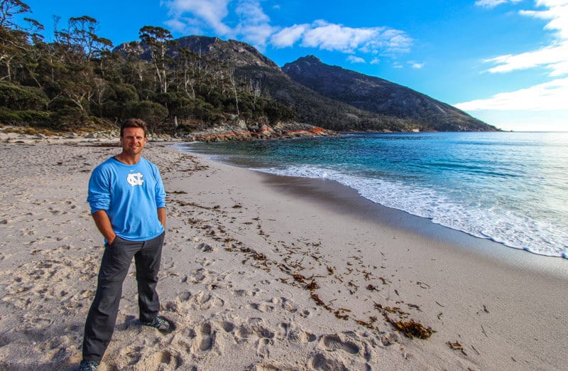 man posing on beach of Wineglass Bay - 