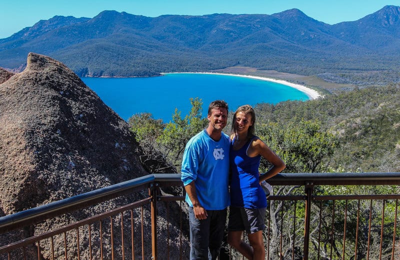 couple posing with view of Wineglass Bay  from The Lookout