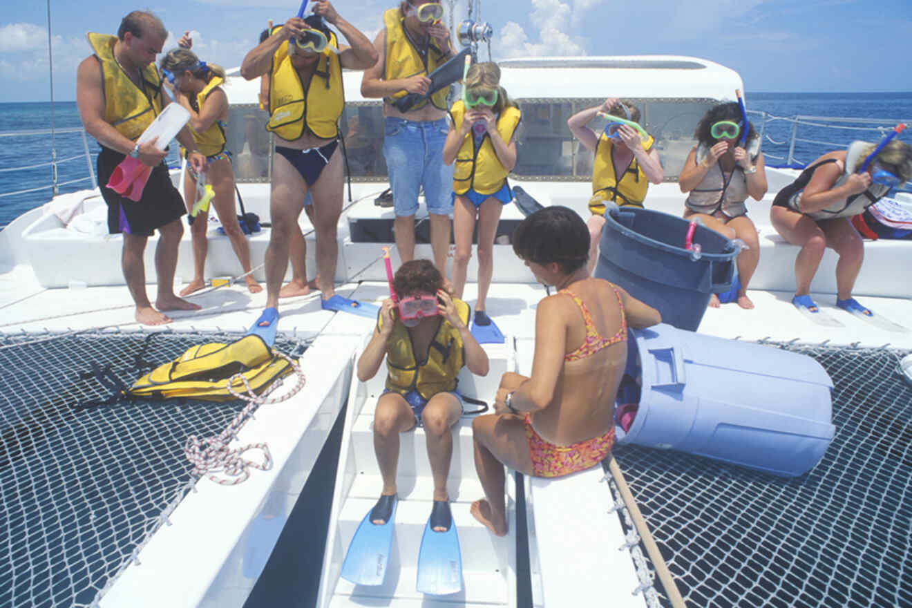 Snorkelers preparing to go in the sea on a boat