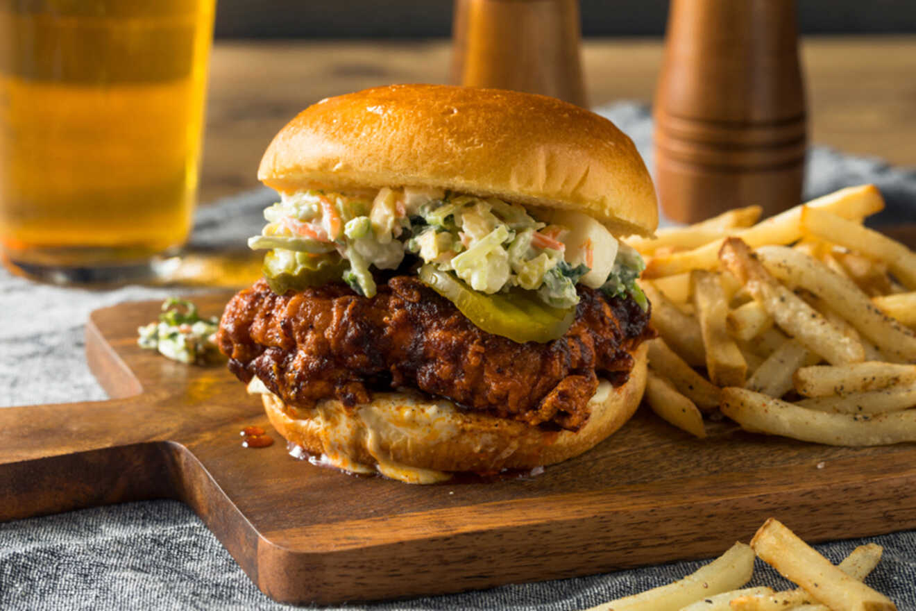 Chicken burger and fries on a wooden board