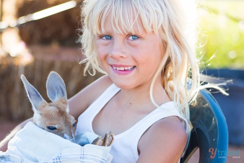 young girl holding joey