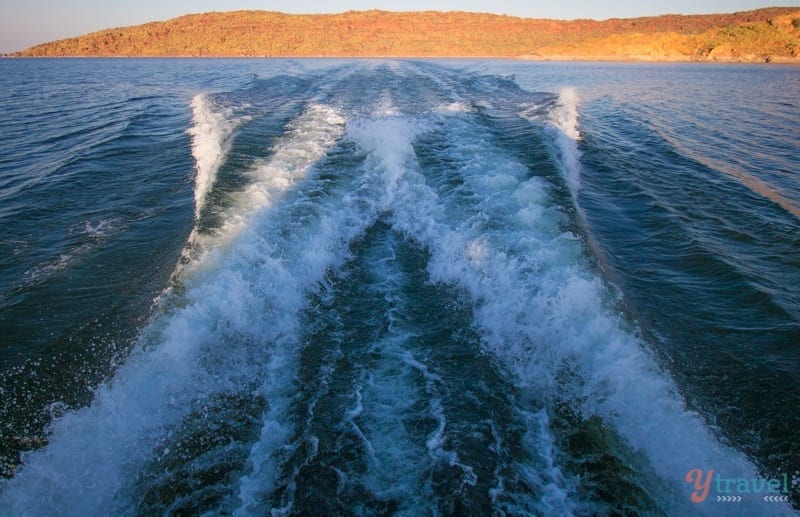 waves in a lake made by a boat