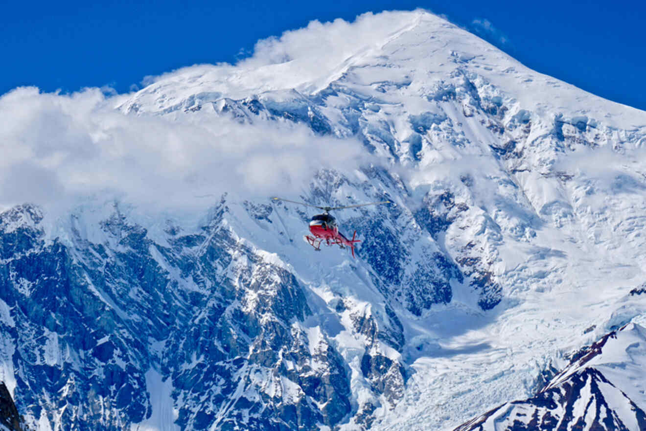 Helicopter flying over snowy mountains