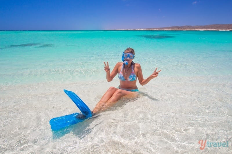 caz sitting in water with snorkel equipment on at Turquoise Bay, Exmouth. Western Australia