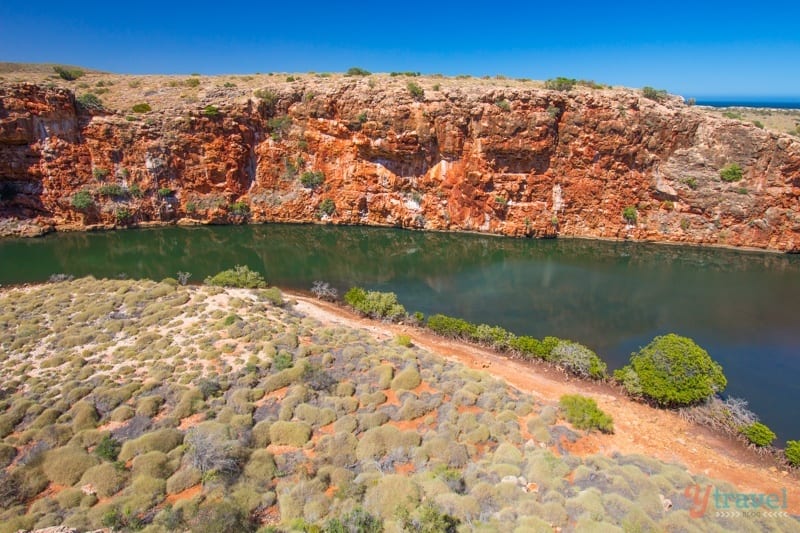 A rocky island in the middle of a body of water