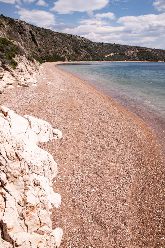 sand and curving beach and water of  Karathoas Beach