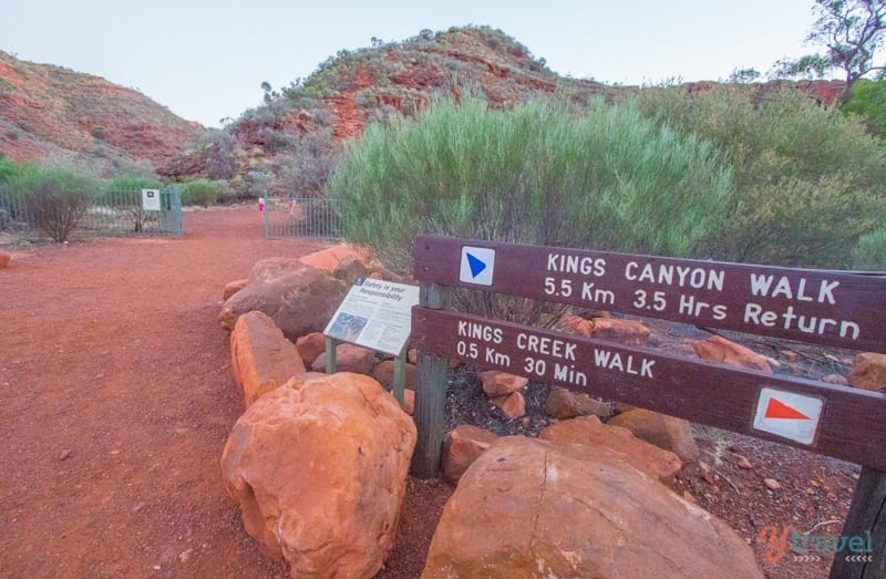 A sign on a dirt trail for kings canyon walk