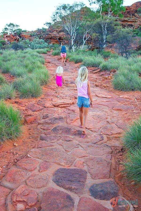 girls walking on a dirt trail