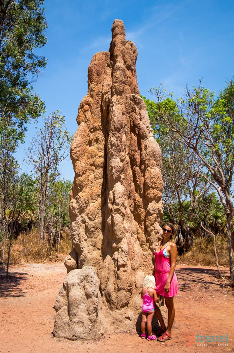 Caz and Savannah standing in front of giant termite mounds 