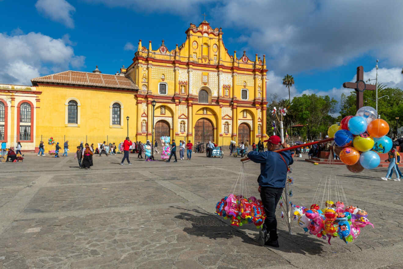 A man carrying balloons in front of the Cathedral