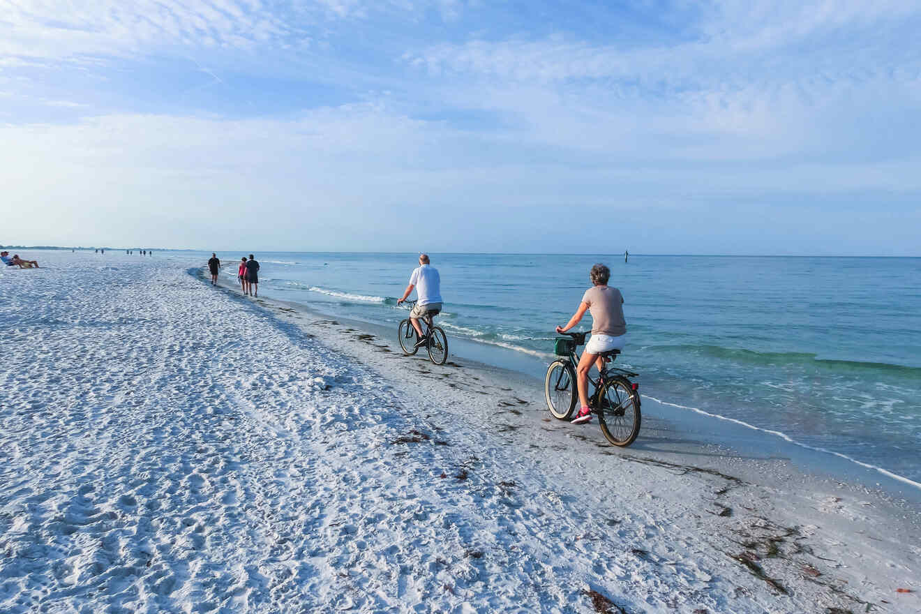 people riding a bike on the beach