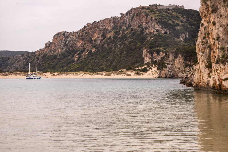 sailing boat in water beside beach