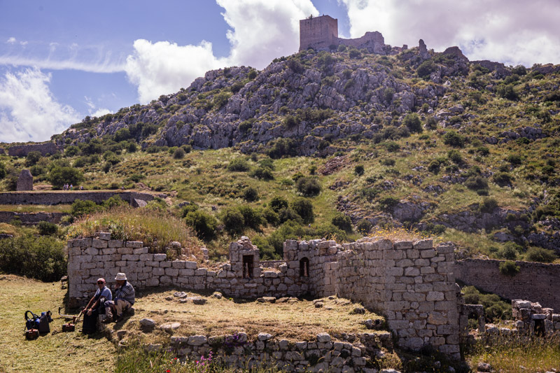 frankish tower on hill with crumbling ruins below