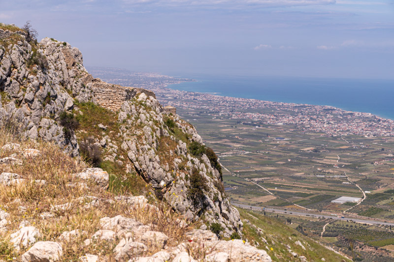 crumbling fortification walls and view over corinth gulf