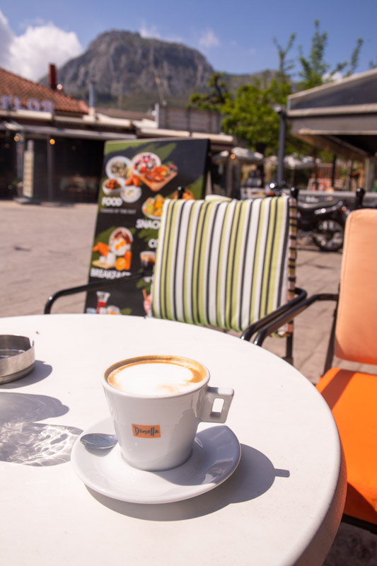 coffee on table at restaurant with views of acrocorinth on the mountain